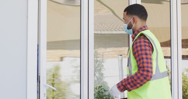 Young Delivery Worker Wearing Protective Mask and Reflective Vest - Download Free Stock Images Pikwizard.com