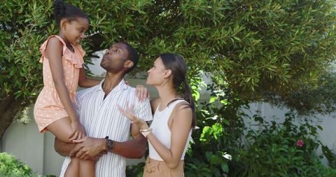 Diverse Family Enjoying Quality Time in Lush Backyard
