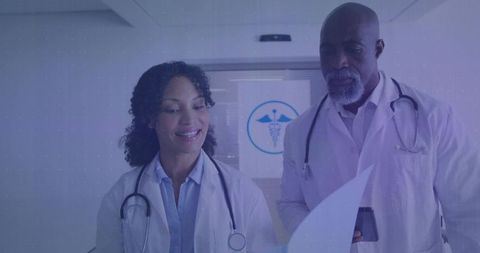 Medical Team Reviewing Documents in Hospital Corridor