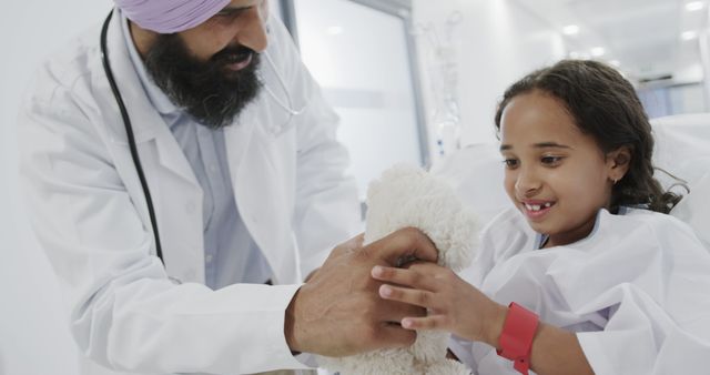 Smiling Doctor Giving Toy to Child in Hospital - Download Free Stock Images Pikwizard.com