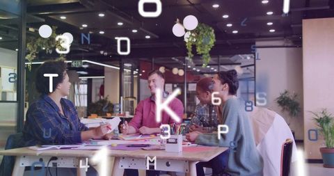 Creative team collaborating at wooden table in modern coworking space with digital overlay