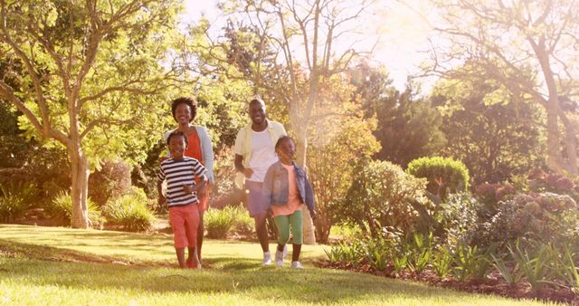 Happy African American Family Enjoying Walk in Beautiful Park - Download Free Stock Images Pikwizard.com