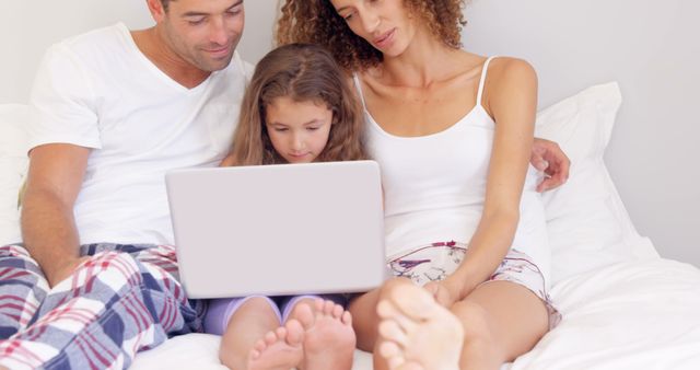 Family Bonding Time Watching Laptop Together in Bedroom - Download Free Stock Images Pikwizard.com