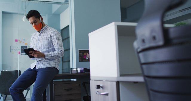 Man Wearing Mask Using Tablet in Modern Office - Download Free Stock Images Pikwizard.com