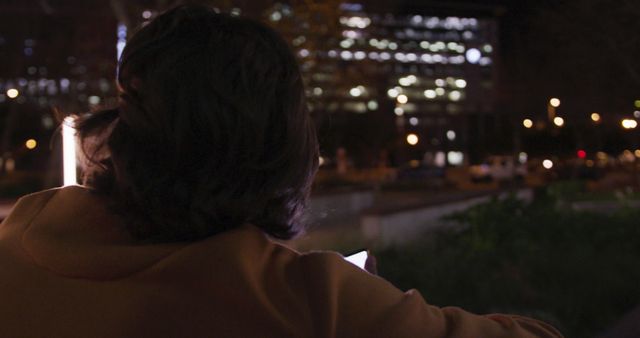 Person Relaxing Outdoors at Night Near City Lights - Download Free Stock Images Pikwizard.com