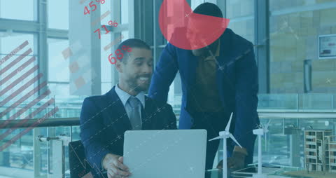 Entrepreneurs Collaborating on Laptop with Overlayed Infographics