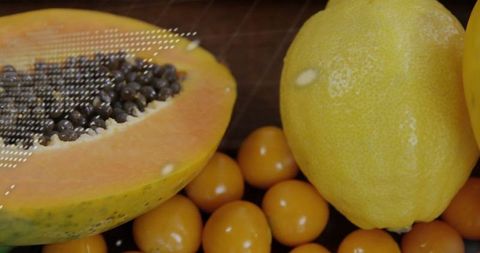 Fresh Tropical Fruits: Kumquats, Papaya, and Lemon Overhead