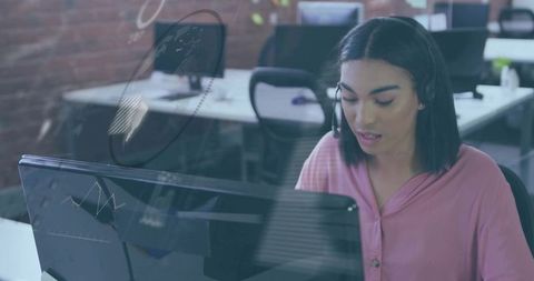 Focused Customer Support Specialist Analyzing Data with Charts Overlay