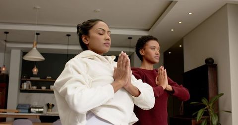 Diverse Women Practicing Yoga in Modern Home