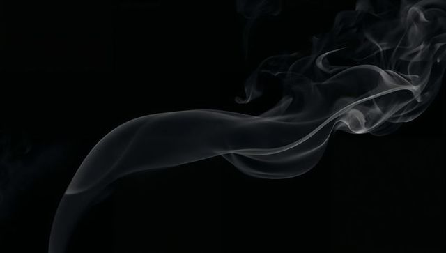 Silver smoke ribbon flowing across deep black space elegant twisting plume of vapor motion