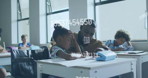 Teacher guiding elementary student one-on-one in bright classroom, child focusing on workbook