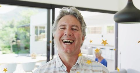 Joyful Man Enjoying Cheerful Moment in Bright Living Room