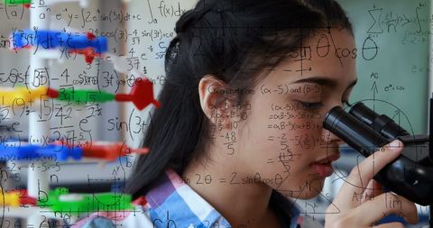 Student exploring science and mathematics with microscope