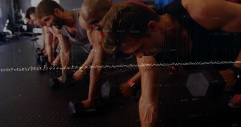 Group Challenge Plank Push-Ups on Dumbbells at Gym