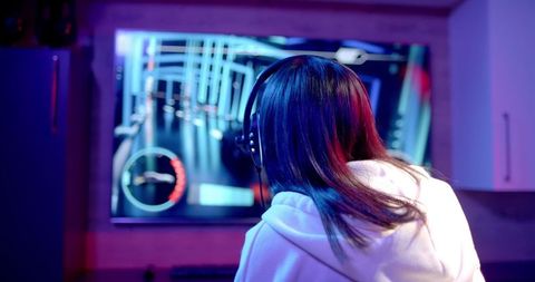 Teenage Girl Immersed in Video Game Wearing Headphones