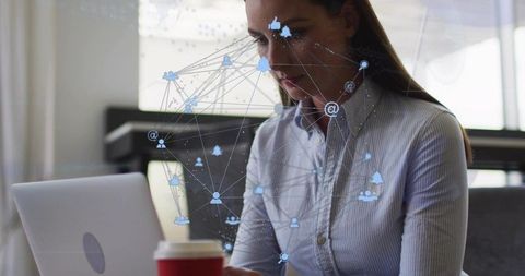 Working woman using laptop in coworking cafe with digital network icons overlay, red cup