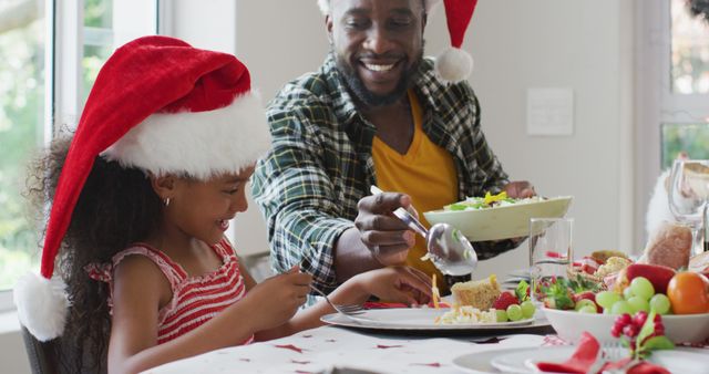 Father and daughter celebrating Christmas having festive meal - Download Free Stock Images Pikwizard.com