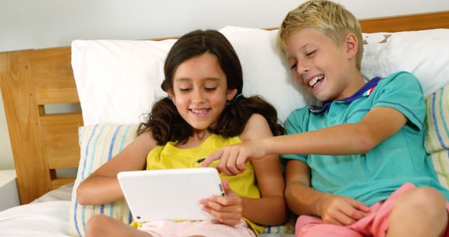 Happy Children Playing on Tablet in Bed - Download Free Stock Images Pikwizard.com