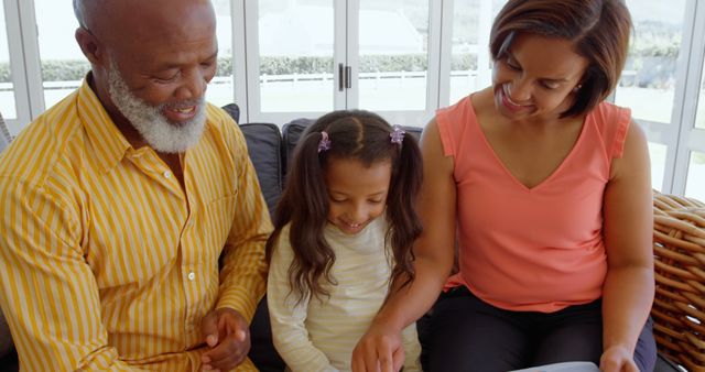 Grandparents Reading with Granddaughter at Home - Download Free Stock Images Pikwizard.com