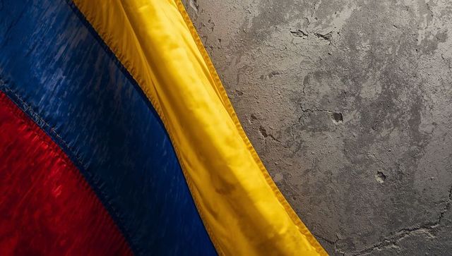 Draping tricolor flag catching light over cracked plaster wall, fabric close-up