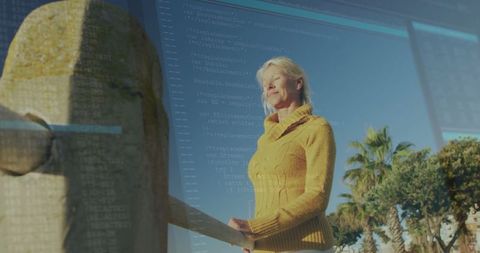 Senior woman in mustard sweater embracing coastal serenity