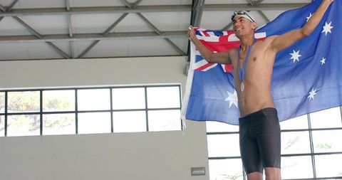 Champion swimmer celebrating victory with australian flag