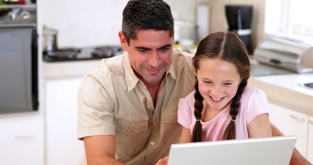 Father and Daughter Bonding While Using Laptop in Kitchen - Download Free Stock Images Pikwizard.com