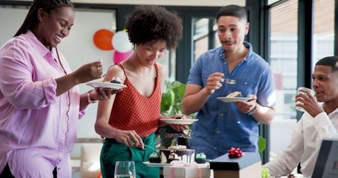 Diverse Team Celebrating Farewell Party with Cake in Office