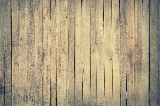 Weathered wooden planks arranged vertically, capturing rustic charm with faded paint. Suitable for backgrounds, design projects, presentations, and websites needing a vintage or natural texture.