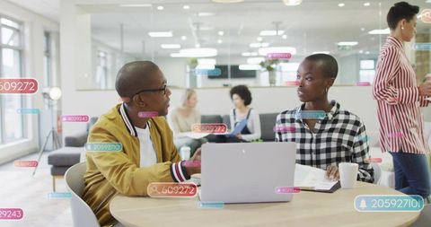 Collaborating in modern coworking space with laptop, discussion and augmented ui overlays