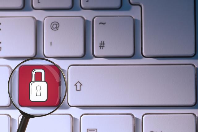 This visual emphasizes the importance of cybersecurity and data protection. The magnifying glass highlighting the padlock icon suggests scrutiny and security measures. Useful for illustrating online privacy issues, secure transactions, and internet safety in blogs, articles, and presentations on technology and security.
