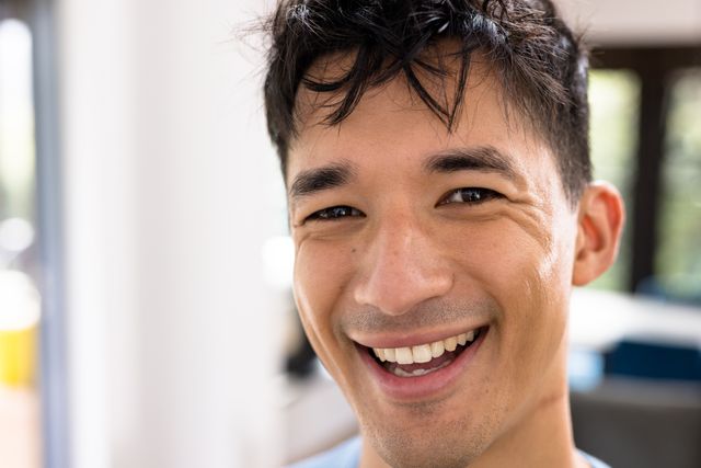 Close-up portrait of cheerful asian handsome young man laughing at home - Download Free Stock Photos Pikwizard.com