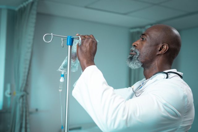 African american male doctor putting drip on tripod in hospital room. medical and healthcare services at hospital