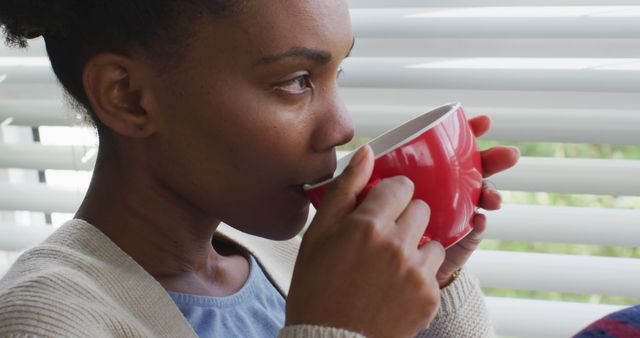 Woman Enjoying Hot Beverage by Window with Blinds - Download Free Stock Images Pikwizard.com