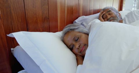 Senior Couple Peacefully Sleeping in Comfortable Bed