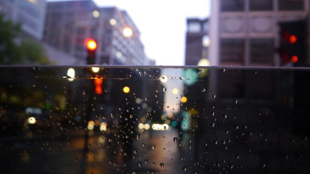 Raindrops on glass with blurry city lights in background - Download Free Stock Photos Pikwizard.com