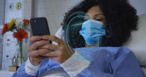 Reclining patient wearing mask and gown using smartphone with telemedicine ar overlay