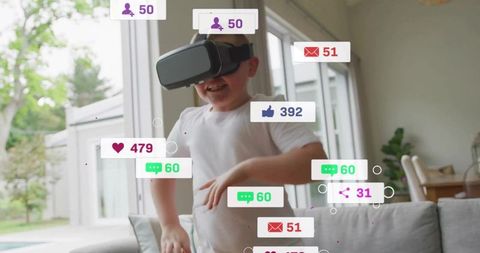 Young boy wearing vr headset reacting to social media notifications in bright living room