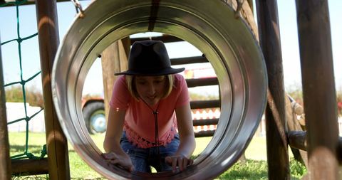 Teenage Girl Exploring Playground Tunnel on Adventure Day