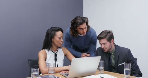 Diverse Team Collaborates Over Laptop in Modern Office - Download Free Stock Images Pikwizard.com