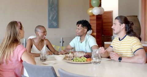 Diverse Friends Sharing Snacks at Dining Table Together