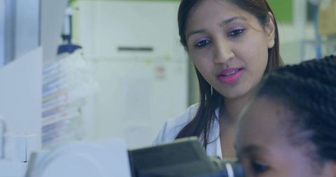 Multiracial scientists conducting research together in laboratory