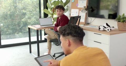 Hispanic colleagues collaborating in modern home office