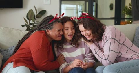 Family Enjoying Holiday Together in Festive Living Room
