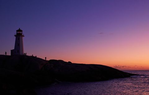 Majestic lighthouse silhouette at lavender twilight