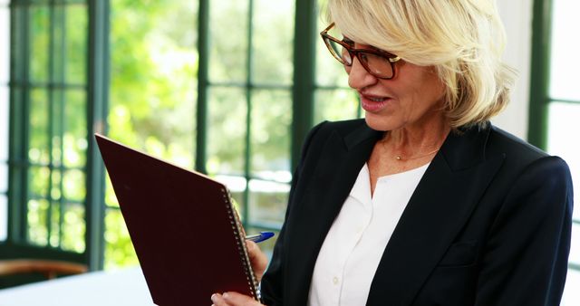 Senior Businesswoman Reviewing Notes in Office - Download Free Stock Images Pikwizard.com