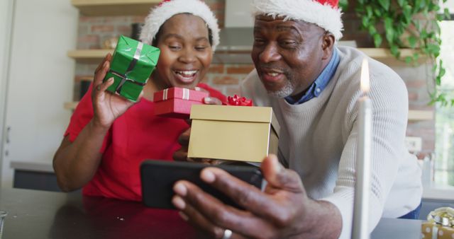 Senior African American Couple Showing Christmas Gift on Video Call - Download Free Stock Images Pikwizard.com