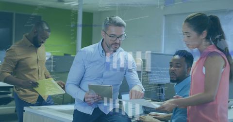 Diverse Team Analyzing Financial Data with Digital Graphics in Office