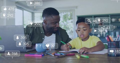 Father guiding son doing homework with social media engagement overlays, home learning