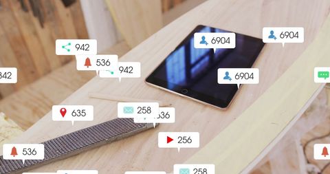 Tablet with Social Media Notifications on Wooden Workbench